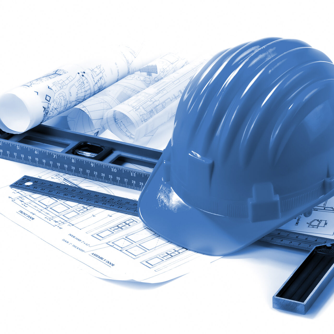 isolated hard hat with tools and blueprint on white
